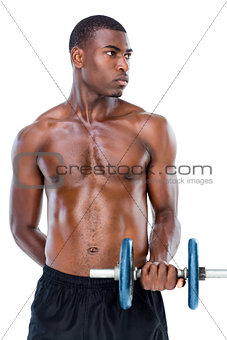 Serious fit shirtless young man lifting dumbbell