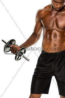 Mid section of fit shirtless young man lifting dumbbell