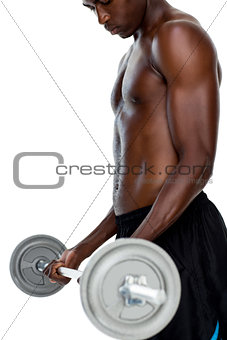 Determined fit shirtless young man lifting barbell