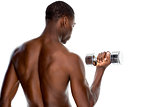 Rear view of a fit shirtless young man lifting dumbbell