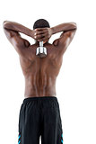 Rear view of a fit shirtless man lifting dumbbell