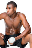Determined fit shirtless young man lifting dumbbell