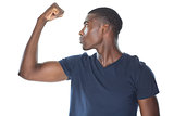 Close up of a casual young man flexing muscles