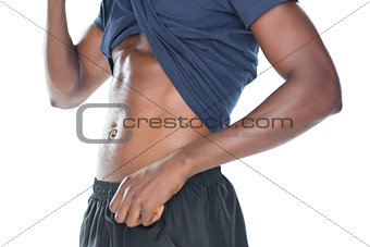 Mid section of a muscular man showing his abs