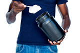 Mid section of man holding a scoop of protein mix