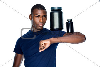 Fit man holding bottles with supplements on his biceps