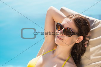 Cheerful woman by swimming pool