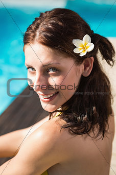 Beautiful woman by swimming pool on a sunny day