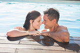 Couple in swimming pool on a sunny day