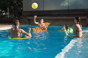 People playing with ball in swimming pool