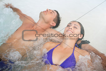 Relaxed couple in swimming pool