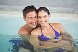 Smiling young couple in swimming pool