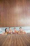 Cheerful people with drinks in the swimming pool