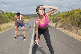 Couple running on the open road together