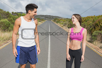 Fit couple standing on the open road