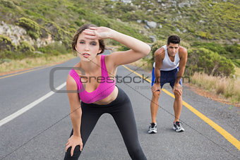 Fit young couple running on road