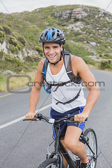 Athletic man mountain biking