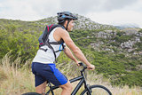 Athletic young man mountain biking