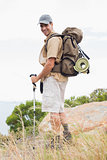Portrait of hiking man walking on mountain terrain