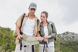 Couple looking at map on mountain terrain