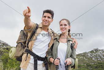 Couple pointing on country terrain