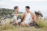 Couple taking break after hiking uphill