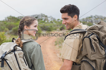 Hiking couple walking on mountain terrain