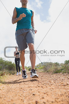 Couple running on countryside road