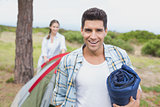 Couple with tent walking on countryside landscape