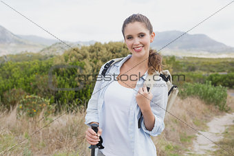 Smiling woman standing on countryside landscape