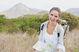 Portrait of a hiking young woman holding map