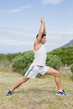 Man doing stretching exercises on countryside landscape