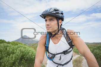 Athletic young man mountain biking