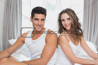 Couple sitting in bed at home