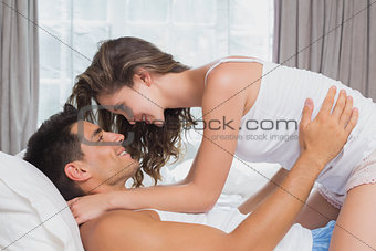 Romantic couple in bed at home