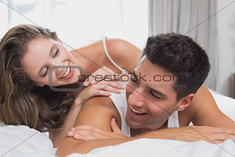 Romantic young couple in bed at home