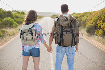 Hiking couple standing on countryside road