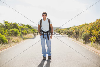 Hiking man walking on countryside road
