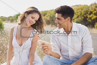 Couple sitting on countryside landscape