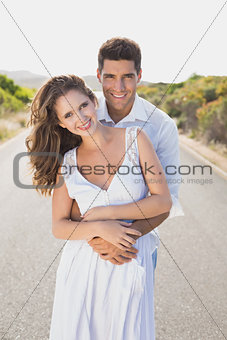Loving couple standing on countryside road