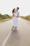 Loving couple standing on countryside road