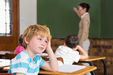 Cute pupil not paying attention in classroom