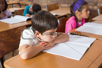 Bored pupil sitting at his desk