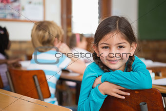 Smiling pupil sitting at her desk