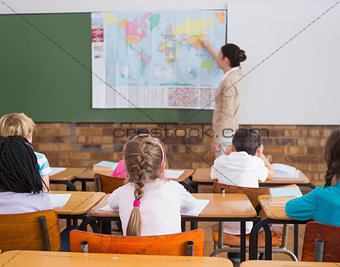 Pupils listening to their teacher at map