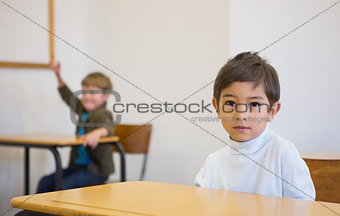Pupil looking at camera at his desk