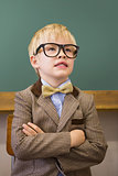 Cute pupil dressed up as teacher in classroom