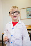 Cute pupil dressed up as scientist in classroom