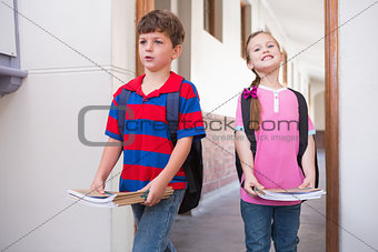 Cute pupils walking into classroom