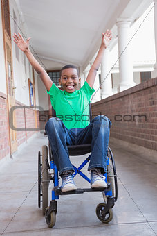 Cute disabled pupil smiling at camera in hall